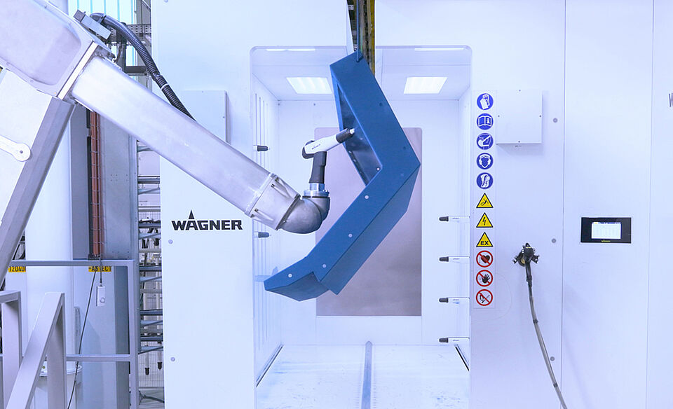 An industrial robot operates in a WAGNER coating booth using a WAGNER spray gun